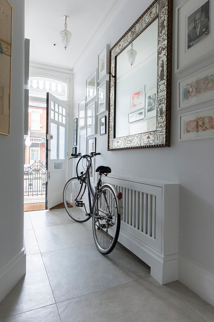 Italian mirror and bicycle in hallway of South London Victorian terrace  UK