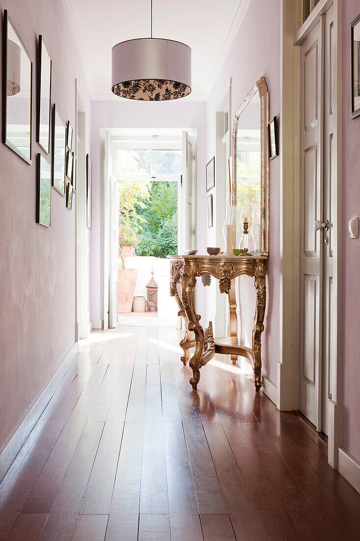 Silver metallic lampshade with gold-painted demi-lune in sunlit hallway, Castro Marim, Portugal
