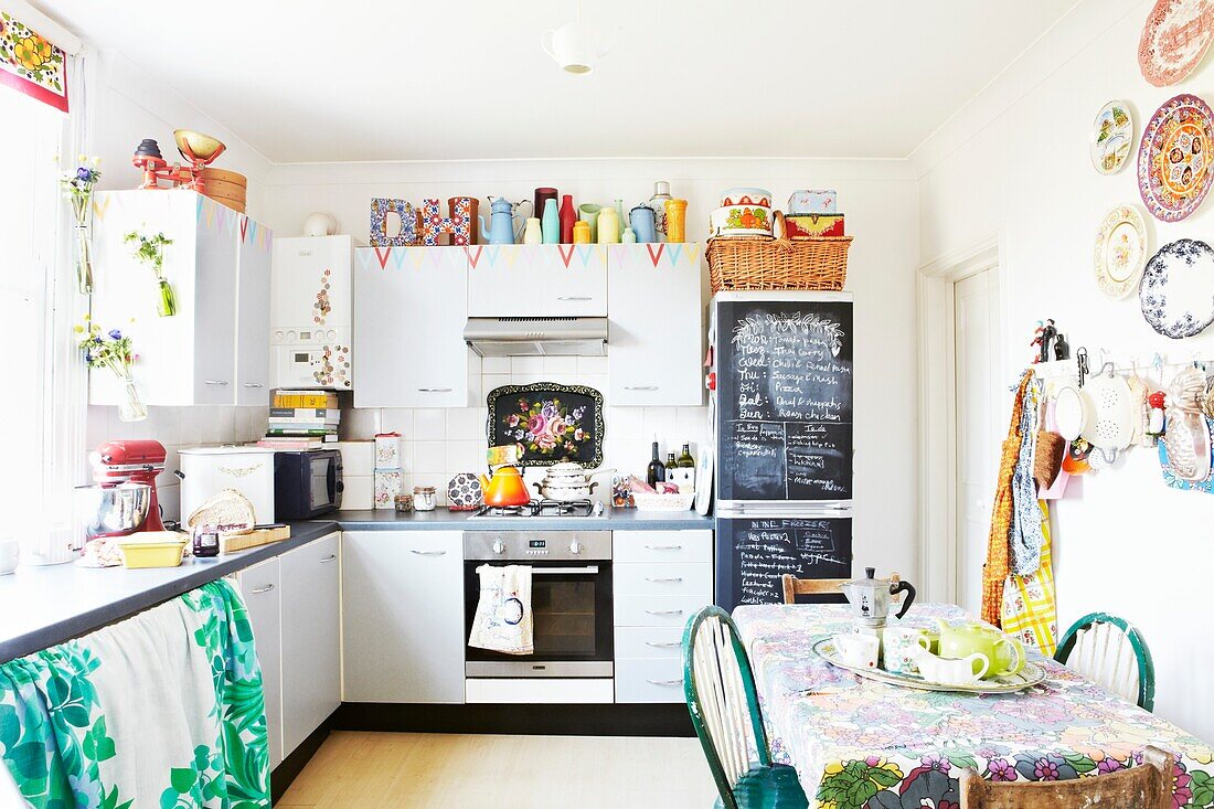 Colourful kitchen with chalkboard in London family home,  England,  UK