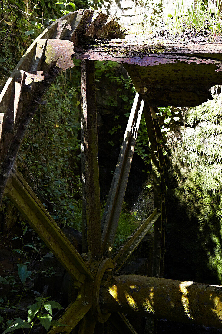 Old iron water-wheel at exterior of rural United Kingdom