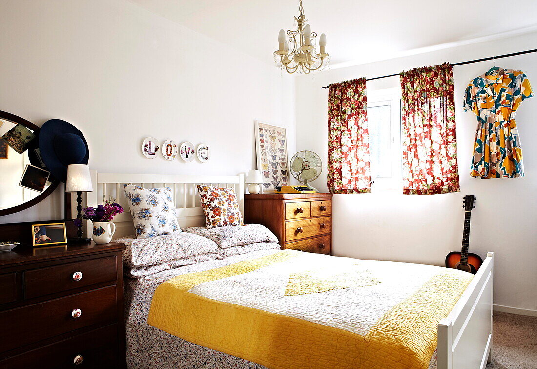 Acoustic guitar in retro style bedroom with yellow quilt in Birmingham home