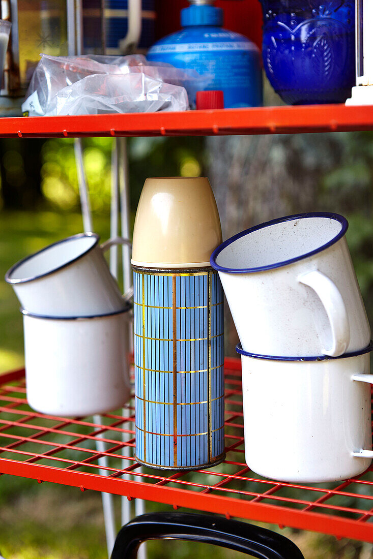 Flask and cups on folding shelf in Brabourne garden,  Kent,  UK