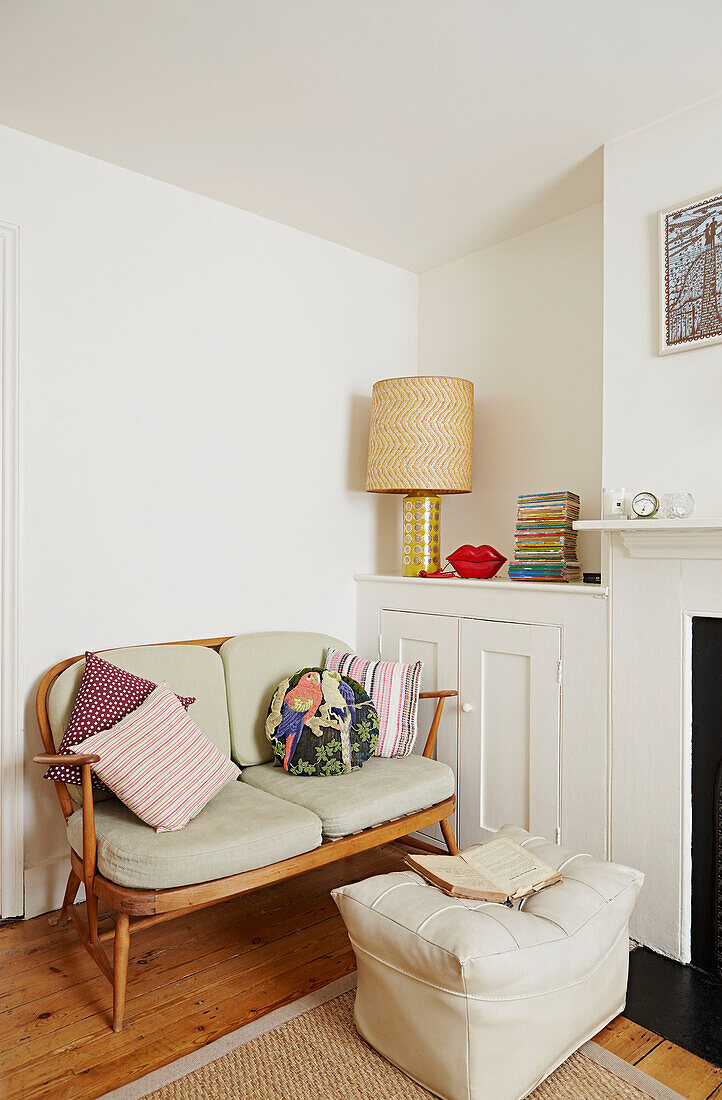 Two seater sofa with lamp and built-in cupboard,  living room of Faversham home,  Kent,  UK