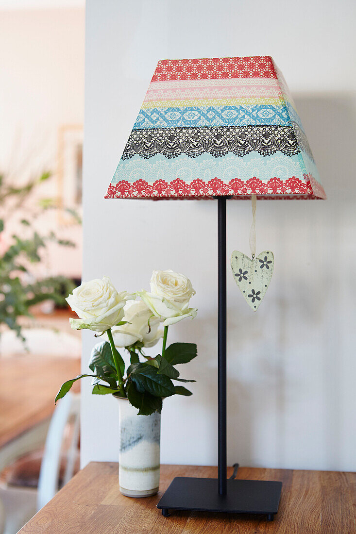 Colourful lampshade with cut roses in Bolton home,  Greater Manchester,  England,  UK