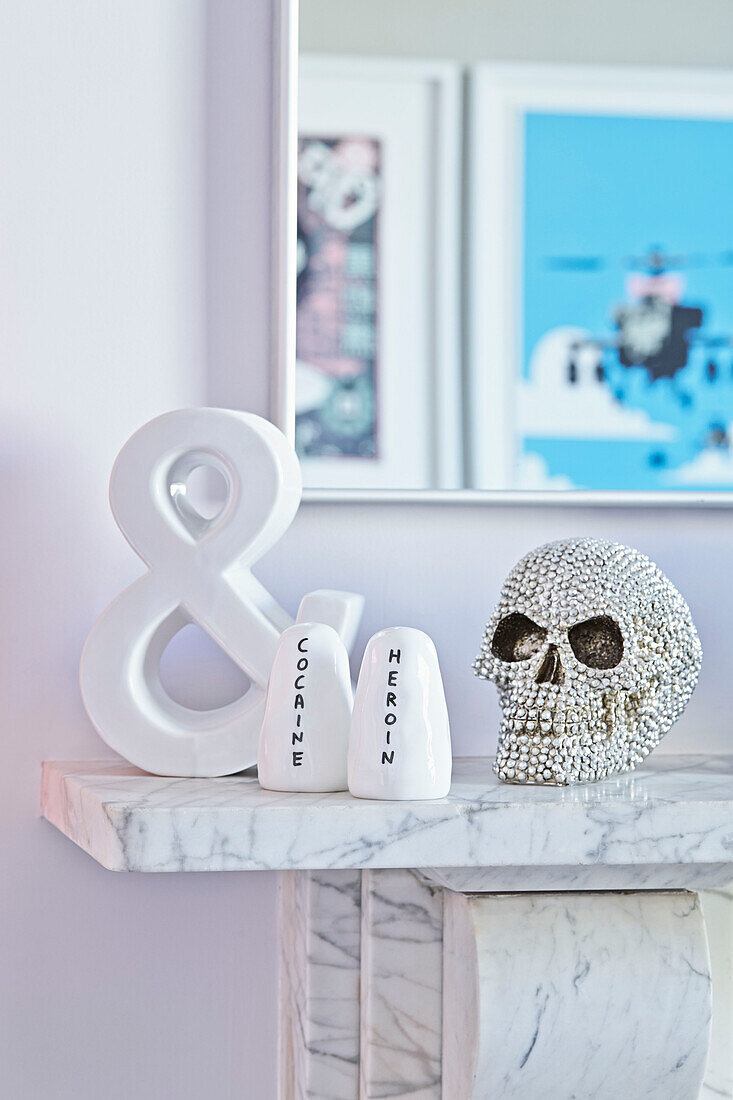 Jewelled skull with salt and cellar pots on marble fireplace in London townhouse  England  UK
