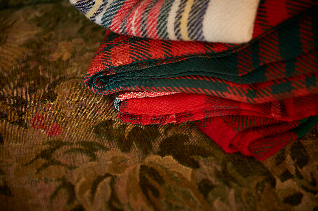 Folded tartan blankets in Rochester home  Kent  UK
