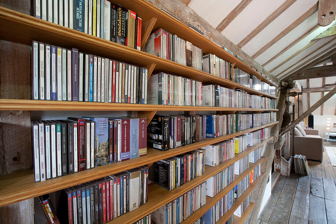 Extensive collections of books on shelving in watermill conversion