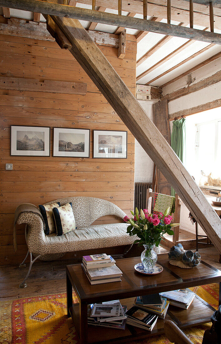 Chaise longue and coffee table with structural beam in watermill conversion