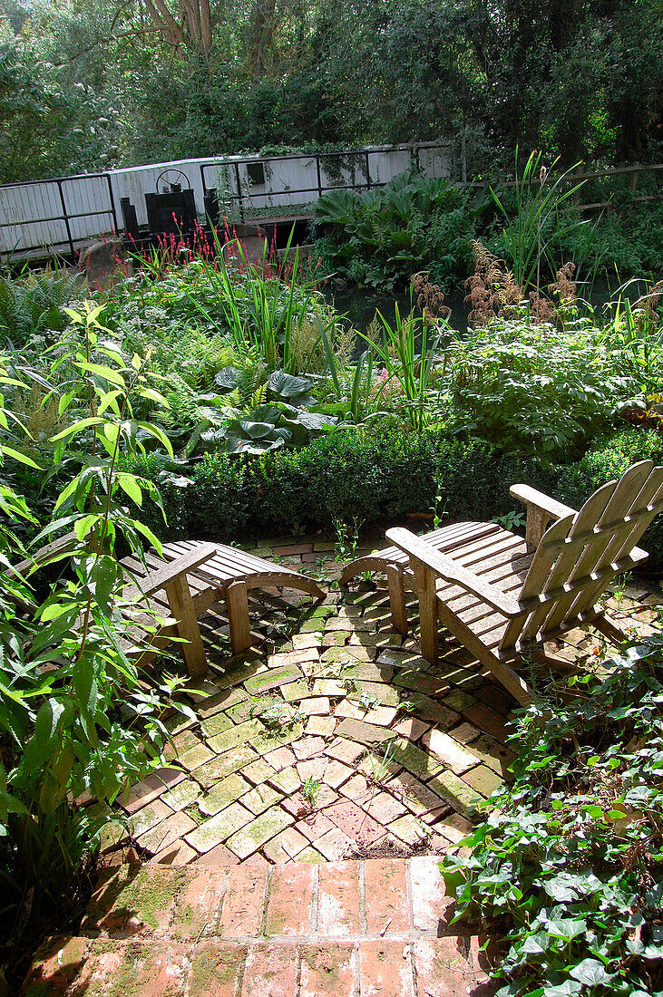 Outdoor chairs on brick patio in garden