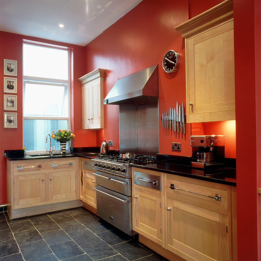 Kitchen with bright red painted walls with solid beech fitted kitchen cabinets