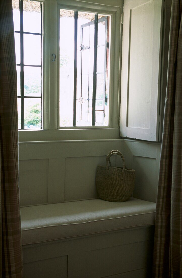 Upholstered window seat with shopping basket