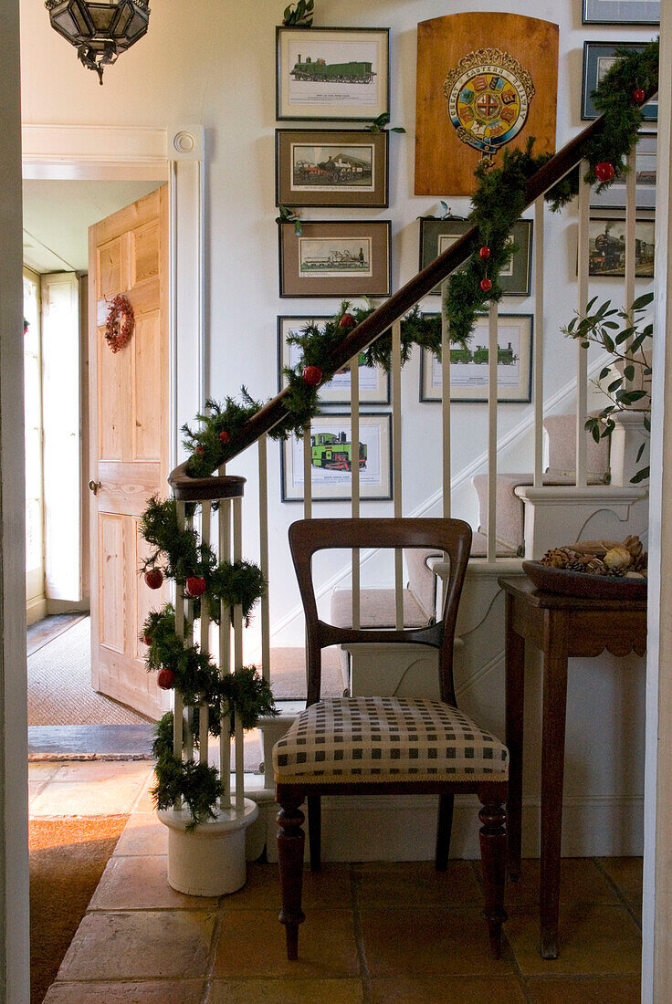 Hallway with festive garland wrapped around the stair banister