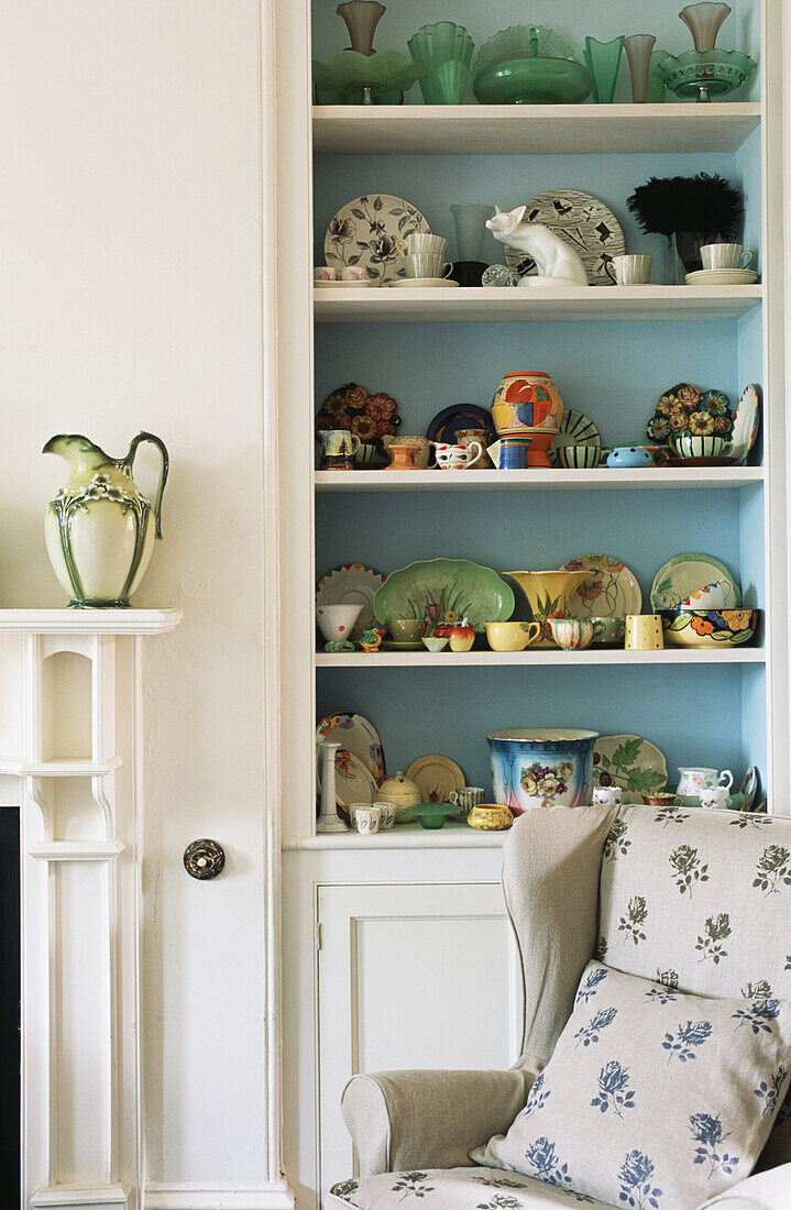 Living room with shelf full of crockery vases and small figurines