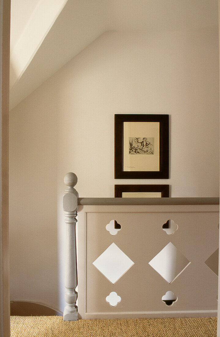 Banister cut from panels of MDF with coir matting and framed prints of Turner and Gainsborough sketches 
