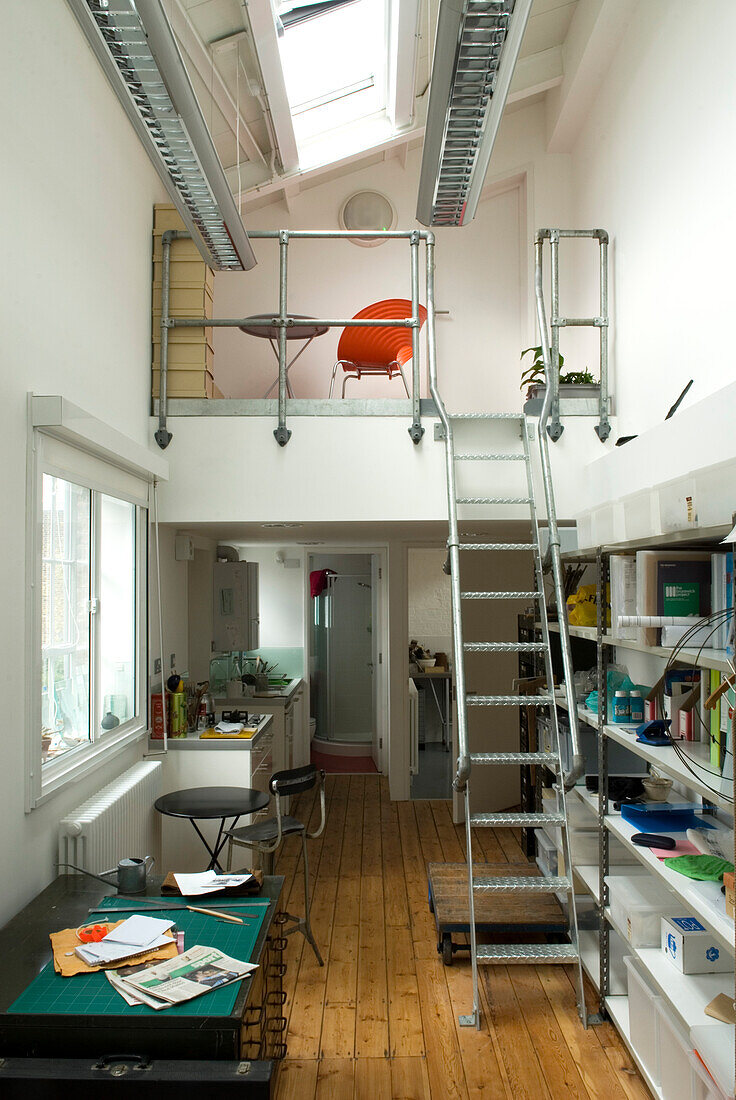 Industrial studio apartment with metal ladder to mezzanine