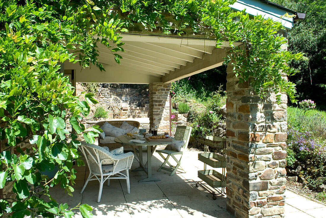 Extended porch offering shade with a vendage table perfect for breakfast