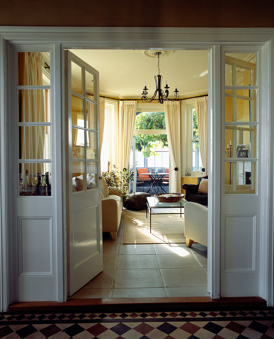 View through open double doors to sunlit living room