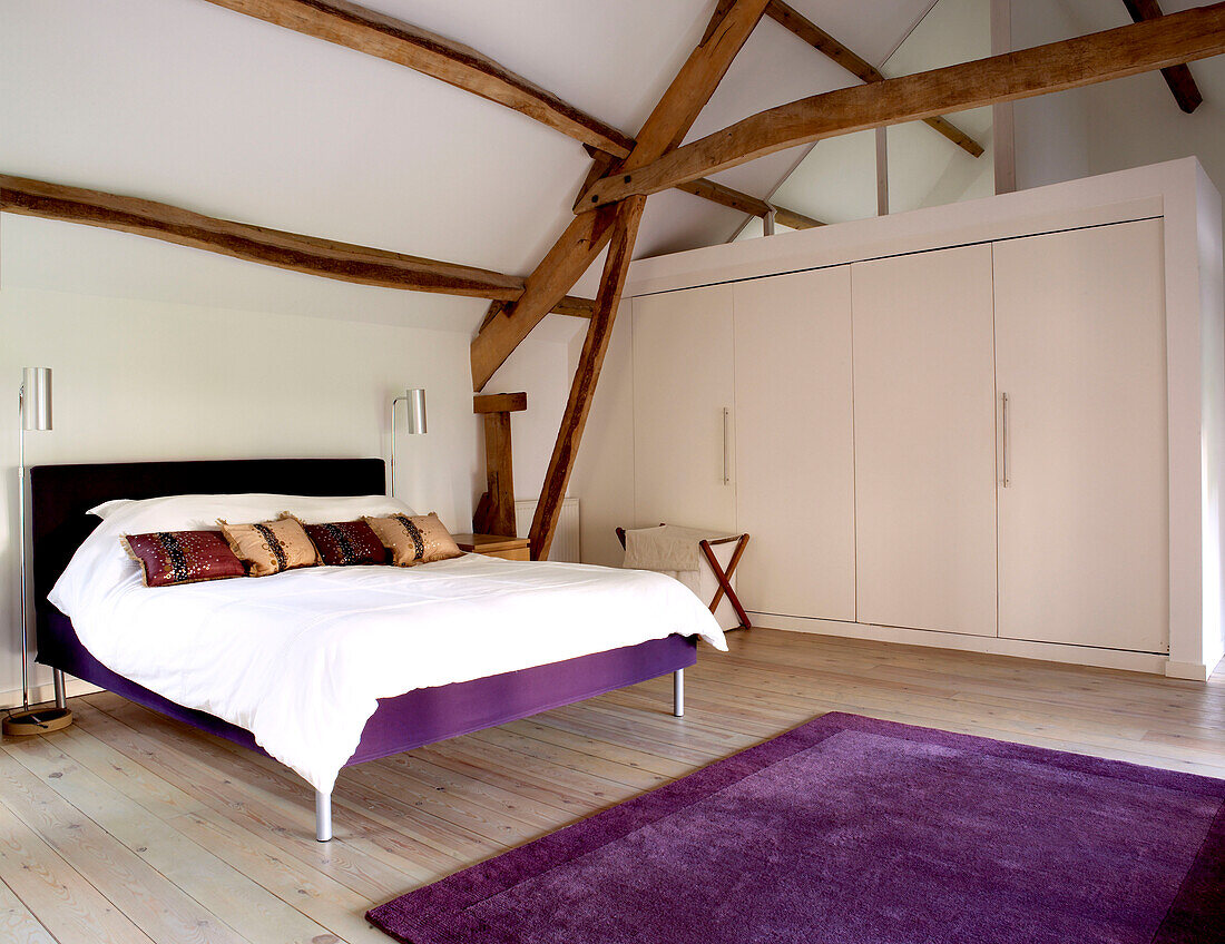 Spacious modern attic bedroom with double bed