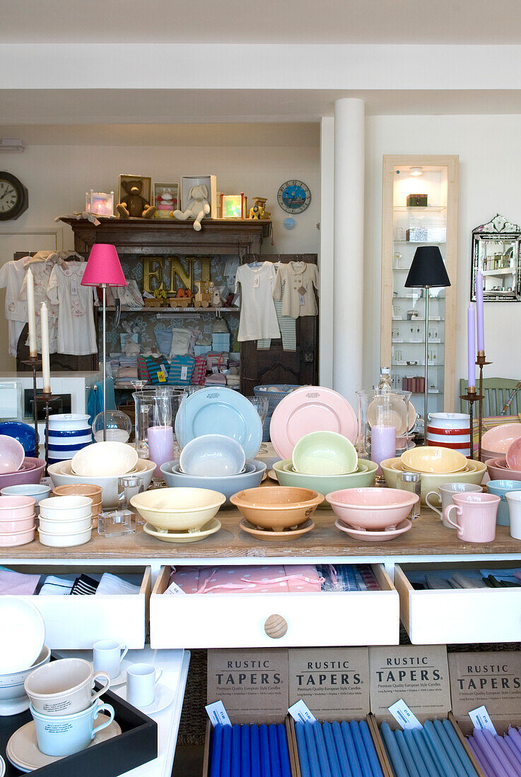 Selection of pastel coloured tableware for sale in shop interior