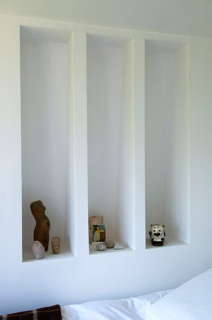 Small figurines and stones on shelf