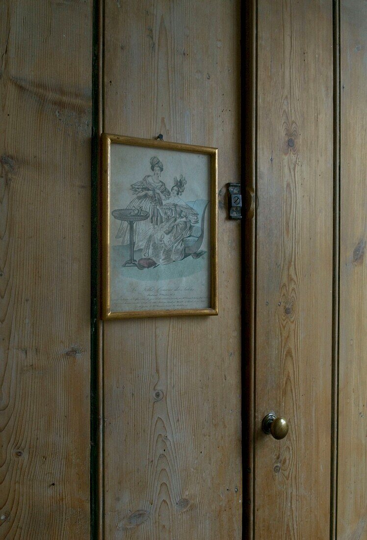 Old print hanging on closet door close-up