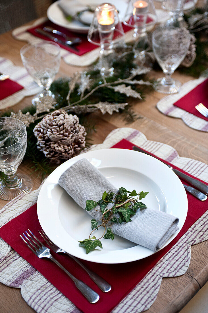 Ivy on napkin at place setting for Christmas dinner in Wiltshire farmhouse