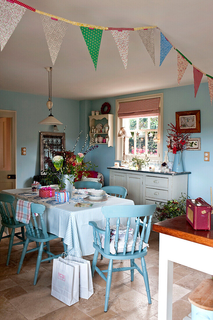 Table and chairs in kitchen with bunting