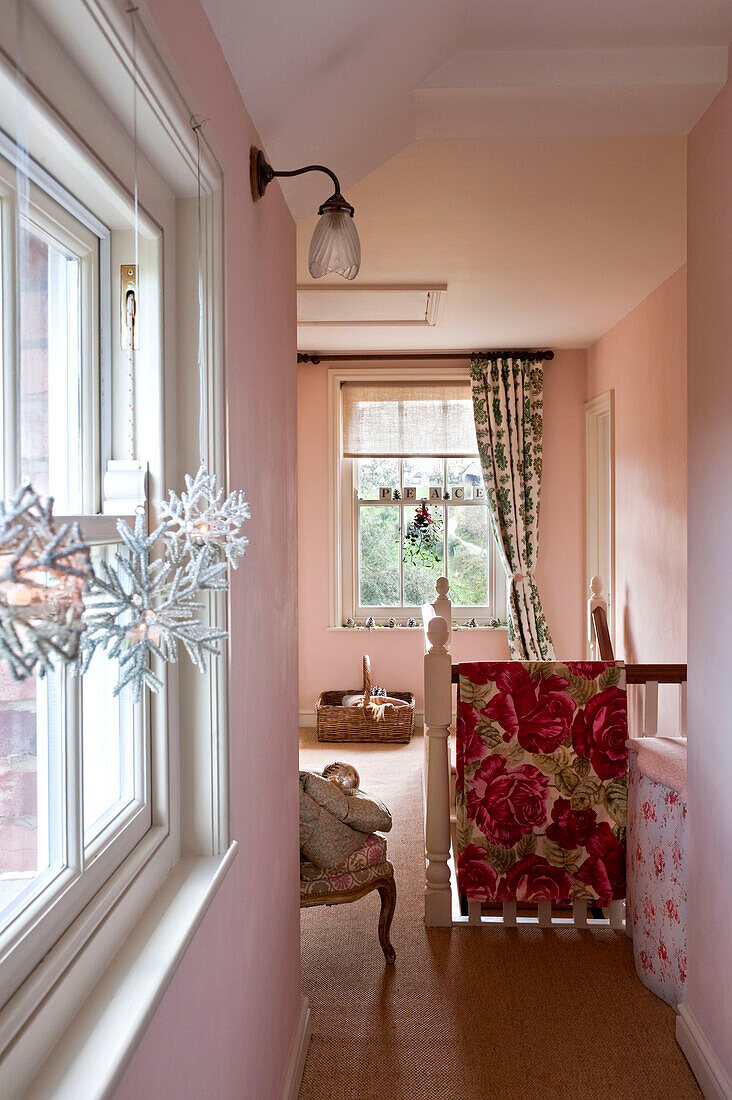 Pink landing with snowflake decorations at window