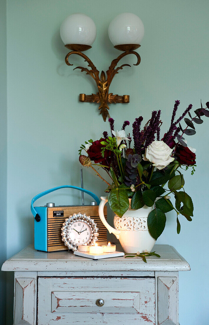 Cut flowers and radio on bedside cabinet