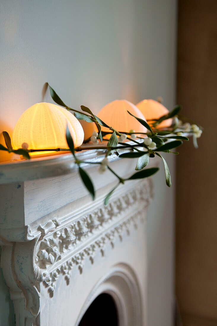 Fairy lights and mistletoe on painted original fireplace