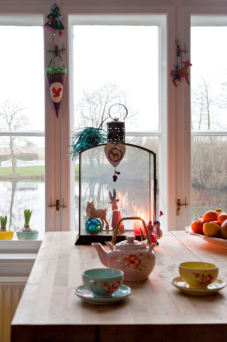 Teapot and cups on wooden kitchen table Odense