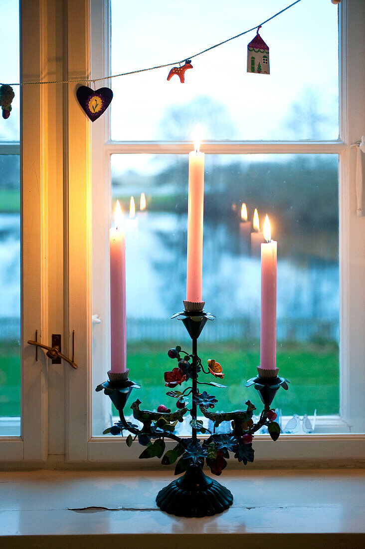 Lit candles on Odense windowsill