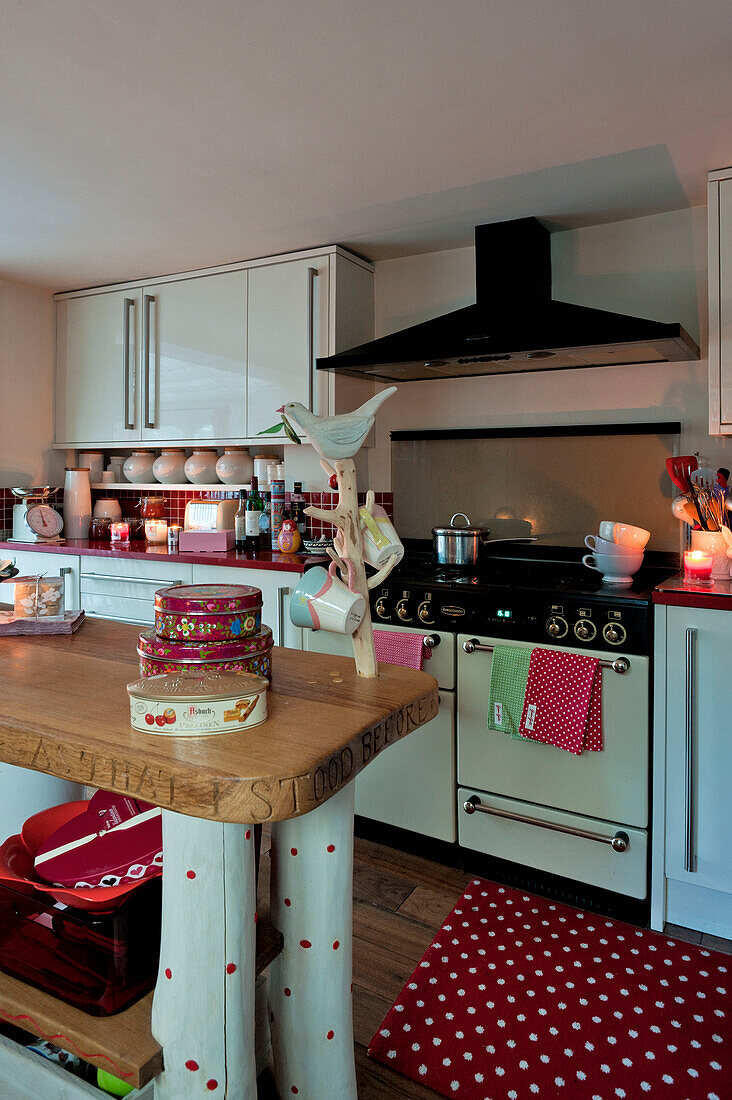 Cake tins on work surface of country style kitchen in London home UK