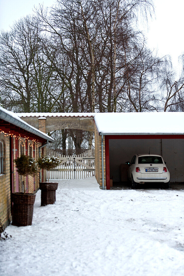 Car parked in garage of farm building conversion on Odense Denmark