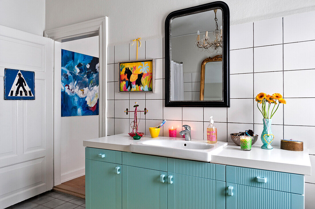 Modern art and pastel blue wash basin unit in bathroom of modern Odense family home Denmark