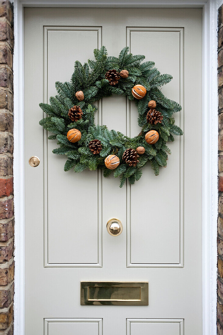 Door wreath with pinecones and dried oranges in Richmond-on-Thames London