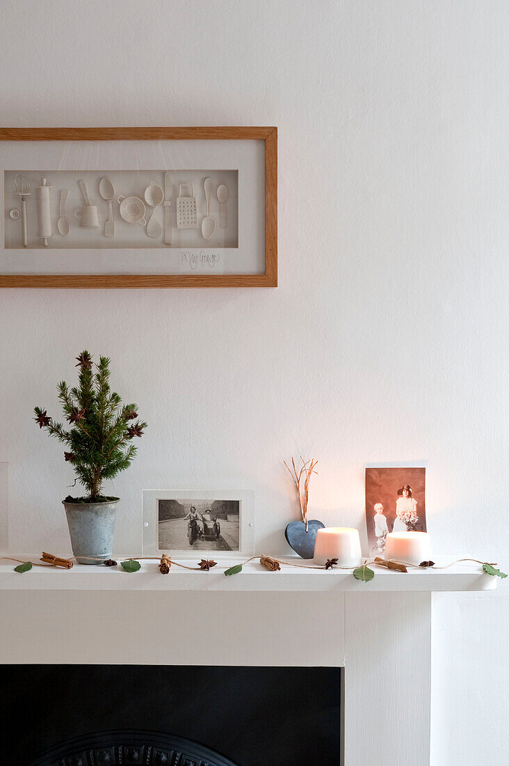 Artwork above very small Christmas tree on mantelpiece Richmond-on-Thames London