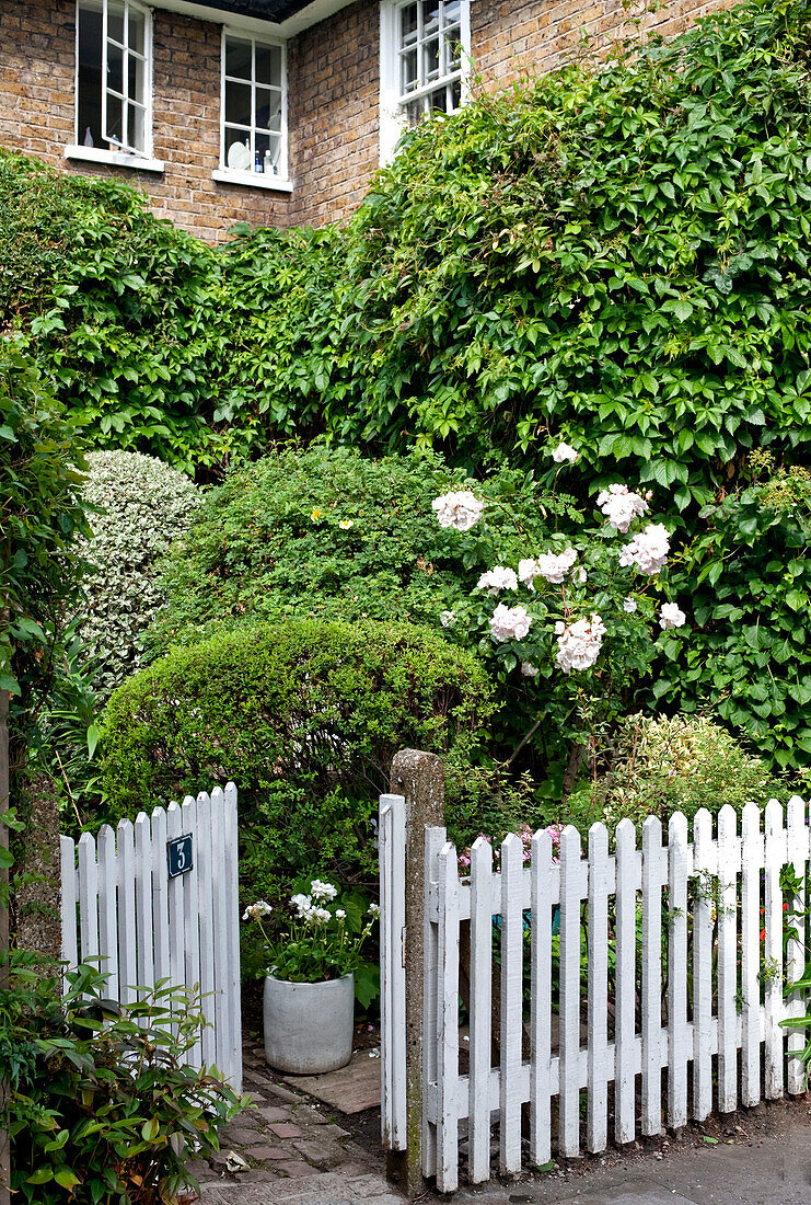 Picket fence and gate at entrance to London home England UK