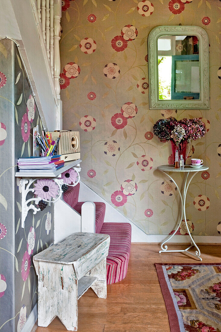 Contemporary floral wallpaper in hallway staircase of London home England UK