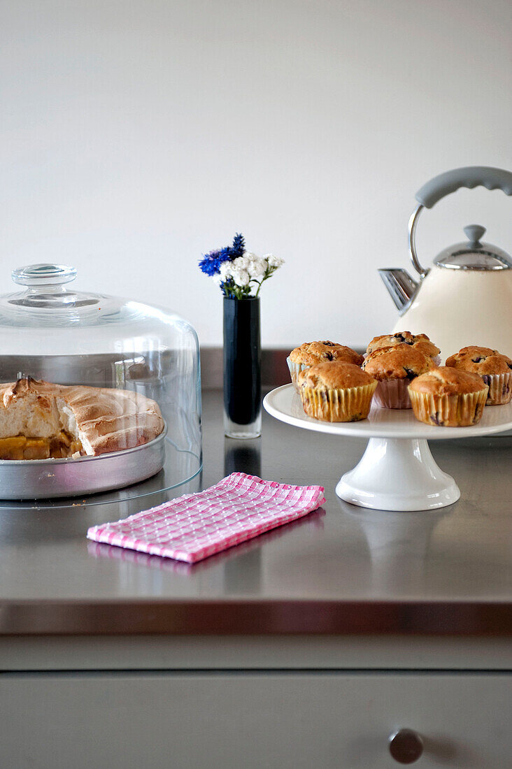 Cupcakes und Meringue mit Wasserkocher auf Arbeitsfläche in Küche in Suffolk England UK