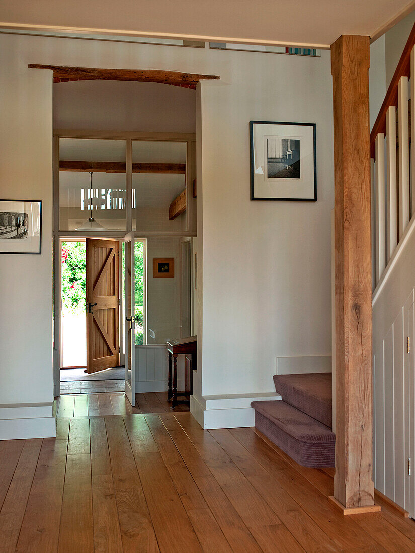 View through open plan hallway to front door of Suffolk family home England UK