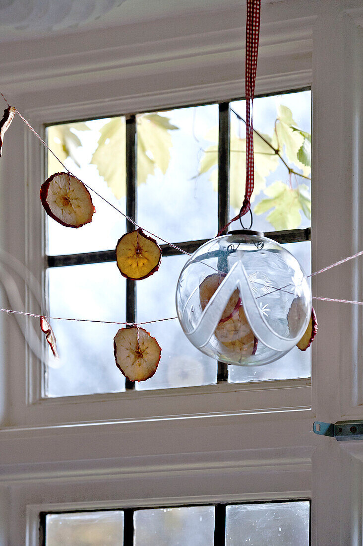 Glass bauble and dried apple Christmas decoration in Forest Row family home, Sussex, England, UK