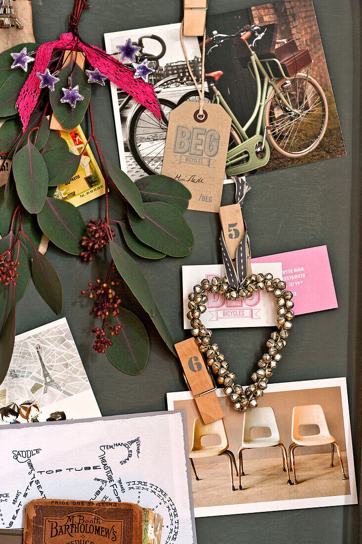 Pinboard memorabilia and leaves on pinboard in Paris apartment, France