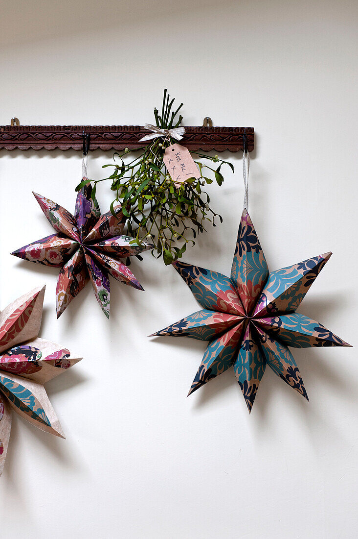 Star shaped Christmas decorations and mistletoe in Walberton home, West Sussex, England, UK