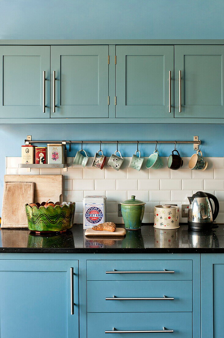 Homeware on counter in fitted kitchen of Bovey Tracey family home, Devon, England, UK