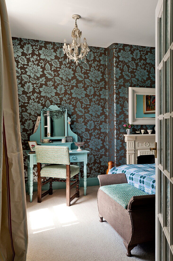 Dressing table with patterned wallpaper in bedroom of Bovey Tracey family home, Devon, England, UK