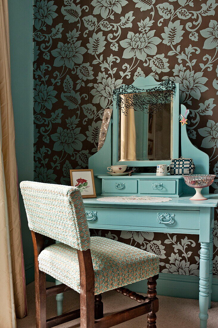 Upholstered chair at dressing table in bedroom of Bovey Tracey family home, Devon, England, UK