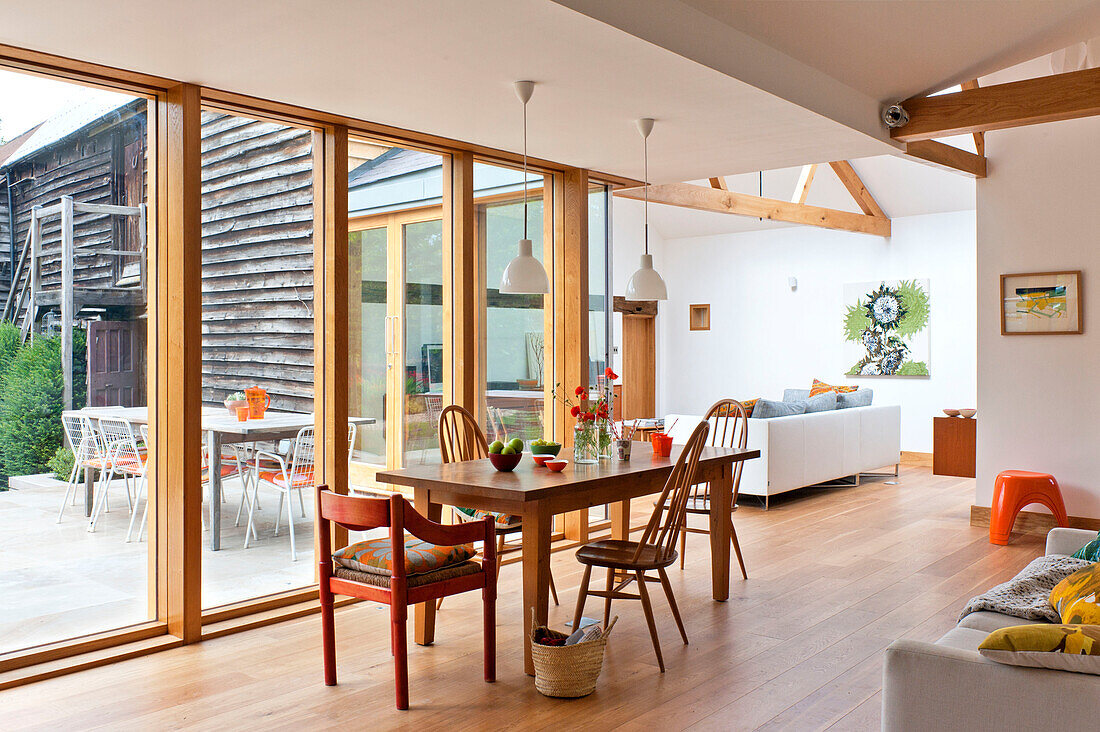 Open plan dining and living room in contemporary Hertfordshire family home, England, UK