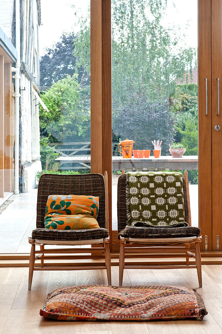 Retro fabrics on vintage chairs in Hertfordshire family home, England, UK
