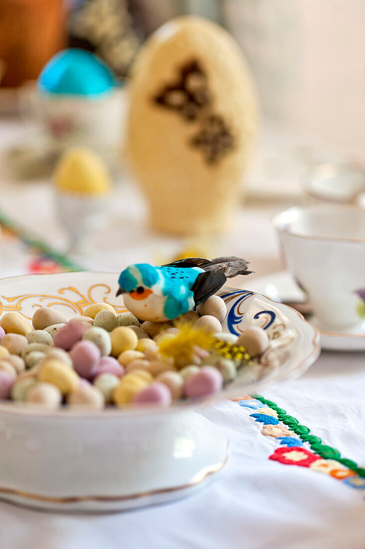 Bird with easter eggs in bowl on table in Essex home, England, UK